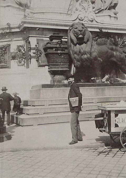 (Hombre delante de una estatua de bronce de león)