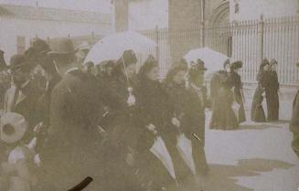 (Mujeres con sombrillas paseando delante de una iglesia)